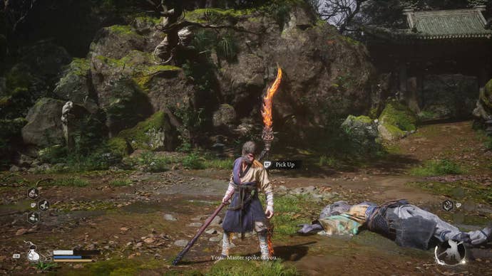 A monkey warrior stands next to a flaming staff in Black Myth Wukong.