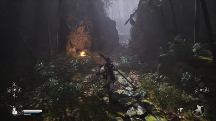 A monkey warrior runs toward a small entrance way in a stone wall in Black Myth Wukong.