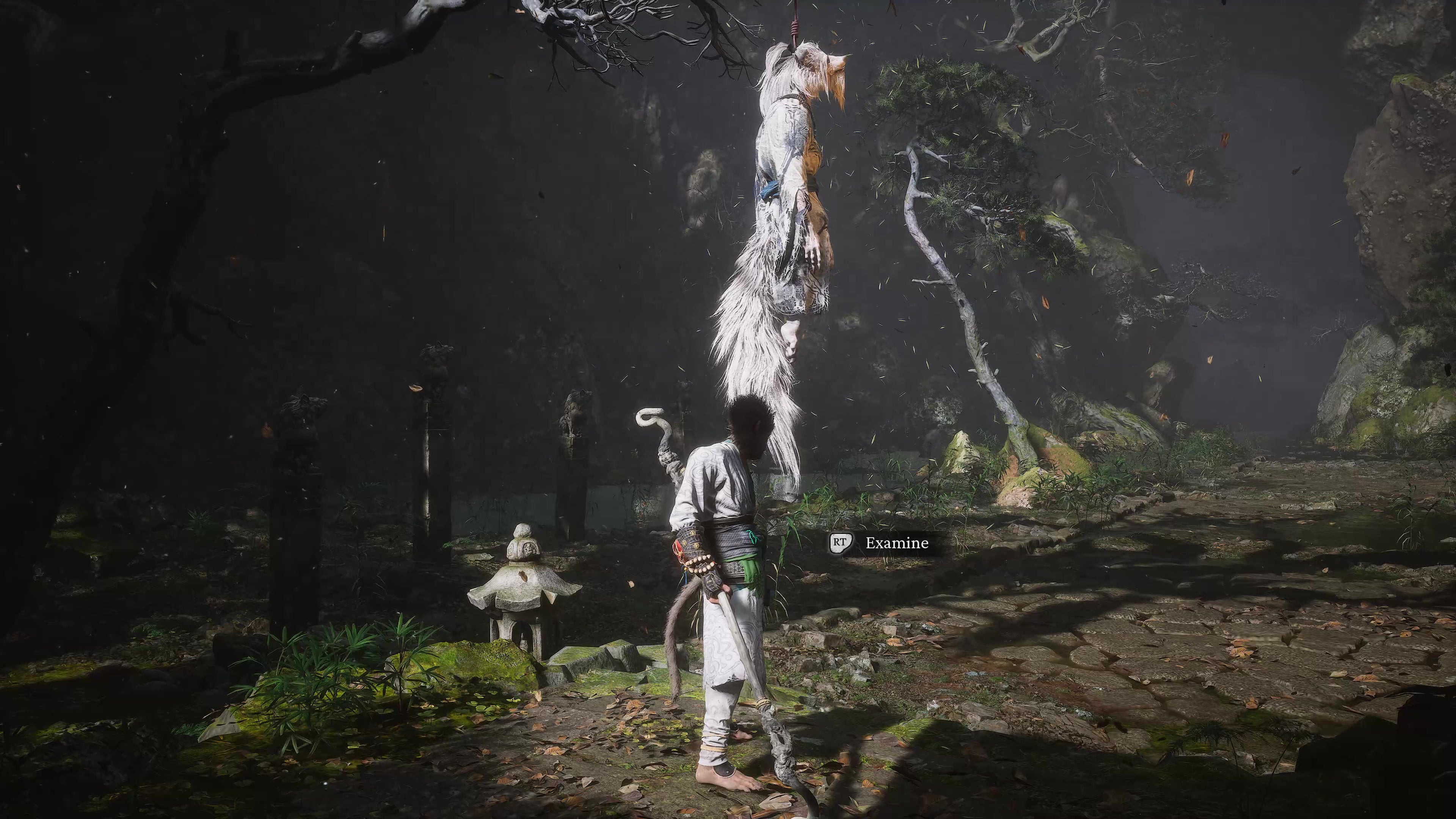 A monkey warrior looks up at a white wolf corpse hanging from a tree in Black Myth Wukong.