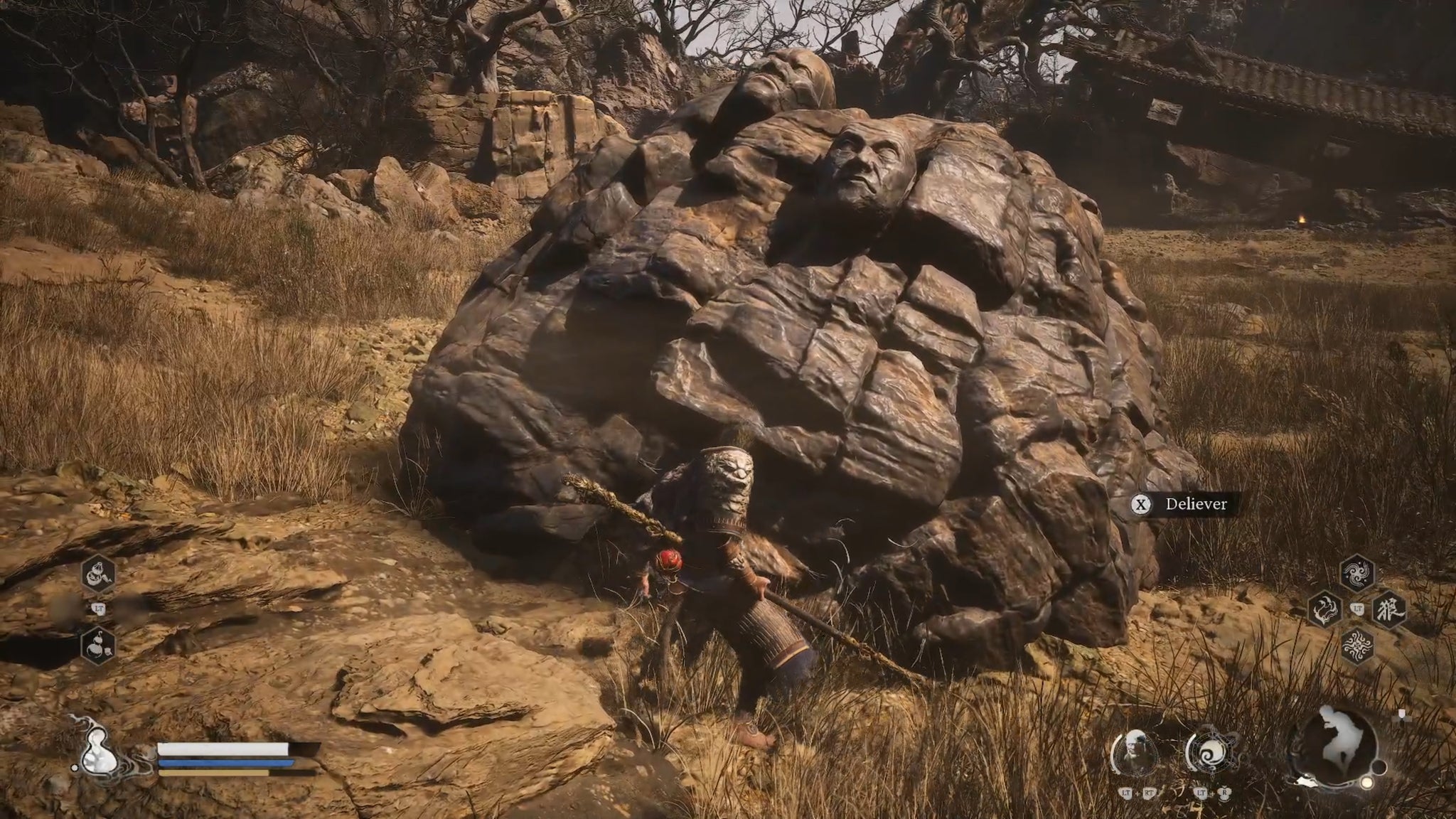 A screenshot of the player in Black Myth: Wukong interacting with a large boulder in an arid landscape. - 16