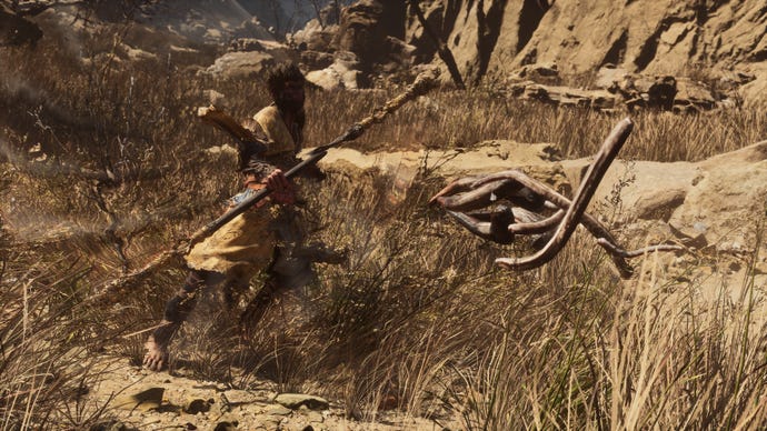 The player in Black Myth: Wukong deflects a projectile attack from an enemy using the Staff Spin ability.