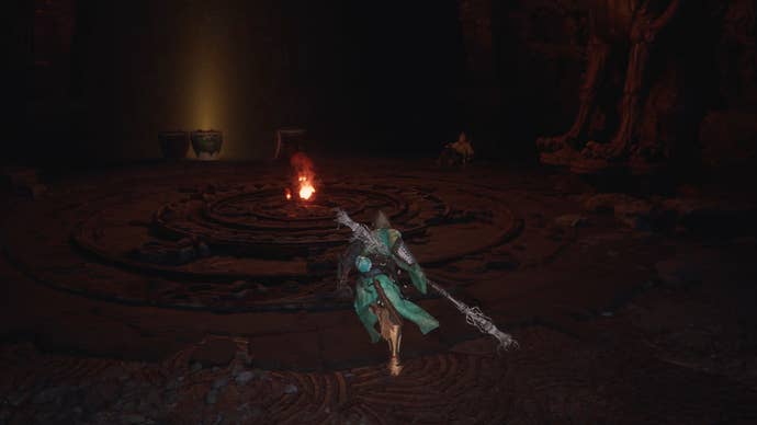 The player in Black Myth: Wukong approaches a room with a flame at its centre, while Yuan Choucheng sits off to the side.