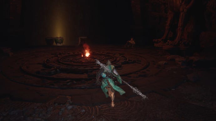 The player in Black Myth: Wukong approaches a room with a flame at its centre, while Yuan Choucheng sits off to the side.