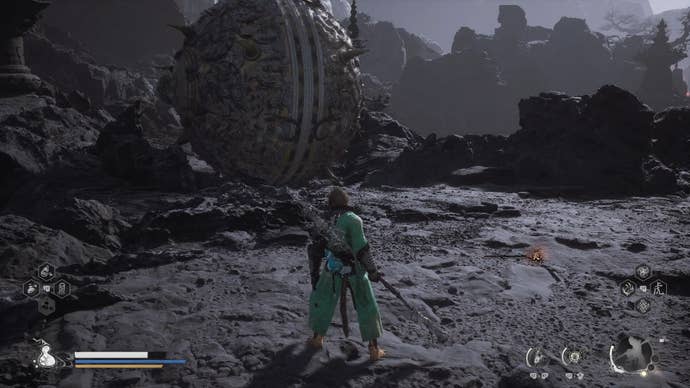 The player stands in front of a giant spiked metal sphere guarding the Ashen Pass III path in Chapter 5 of Black Myth: Wukong.