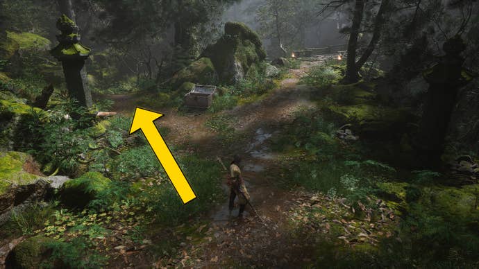 The player in Black Myth: Wukong travels along a path through the Forest Of Wolves in Chapter 1. A yellow arrow points towards the location of the waterfall hiding a secret boss.