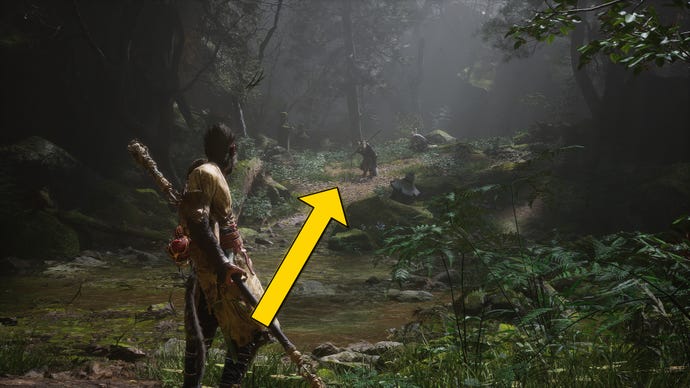 The player in Black Myth: Wukong travels along a path through the Forest Of Wolves in Chapter 1. A yellow arrow points towards the location of the waterfall hiding a secret boss.
