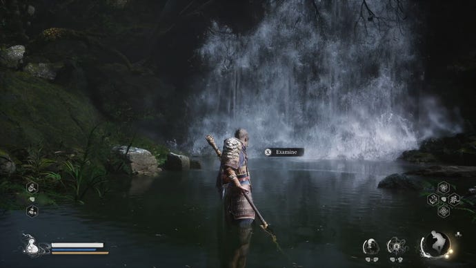 The player in Black Myth: Wukong interacts with a waterfall hiding a secret boss in the Forest Of Wolves in Chapter 1.