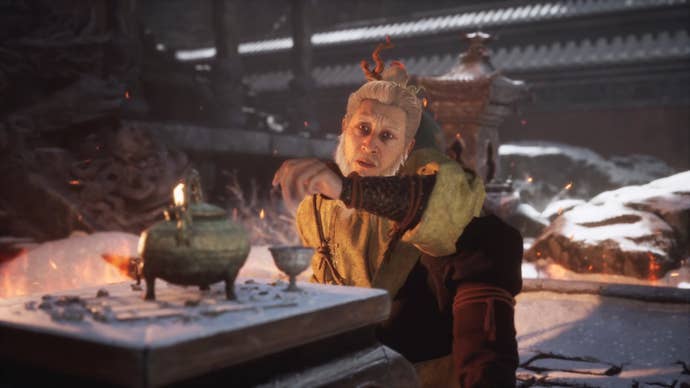 A close-up of Yuan Choucheng, a key NPC in Black Myth: Wukong, sitting by a table in the snow outside.