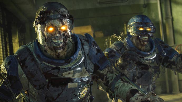 A screenshot from Call of Duty: Black Ops 6’s Zombies mode showing two armour-clad zombies shambling in a dingy room.