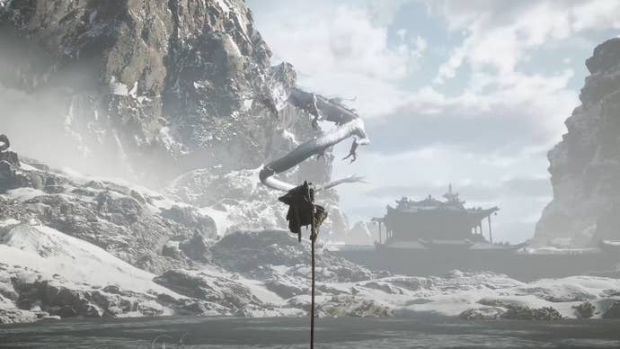 Sun Wukong sits on his staff as an electric dragon stares him down.