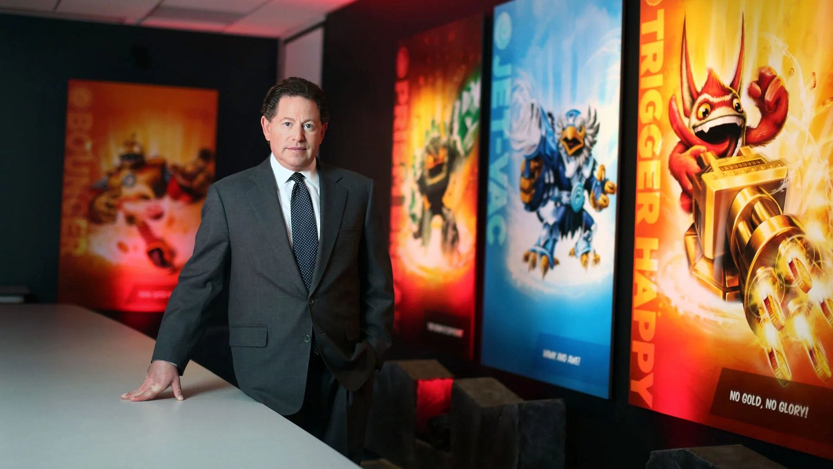 Bobby Kotick standing in front of some Skylanders posters. - 1