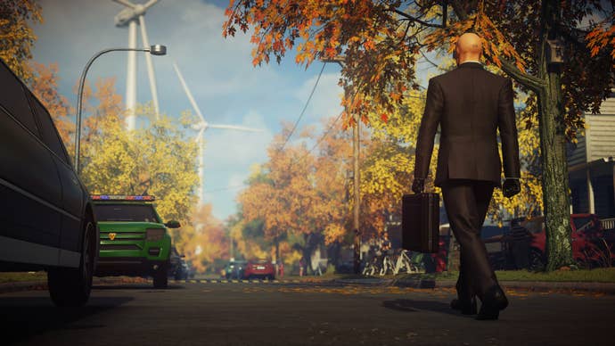 Agent 47 in Hitman 2 walking down a street.