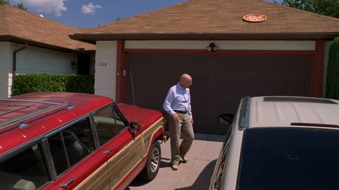 Walter White is walking away from his house having just thrown an entire pizza onto its roof in Breaking Bad.
