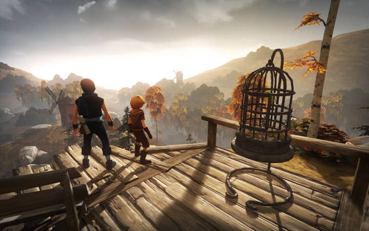 Brothers: A Tale of Two Sons screen showing the two brothers on a deck elevated above a forest, looking off toward distant mountains as the sun rises