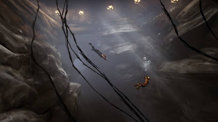 Brothers: A Tale of Two Sons screenshot showing the younger brother sinking in a flooded cave, air bubbles spewing from his mouth. The older brother is diving in and swimming towards the younger one.