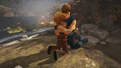 Brothers: A Tale of Two Sons screenshot showing the game's two young brothers kneeling and hugging next to a stream. The younger brother has buried his face in the older brother's shirt. The older brother's eyes are closed with his head pointing down and to the side.