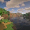 A screenshot of a river in Minecraft, with some trees on either side of the bank and a hill in the distance, taken using BSL shaders.
