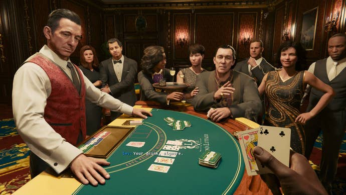 A card dealer at a casino waits for the player to reveal their hand.