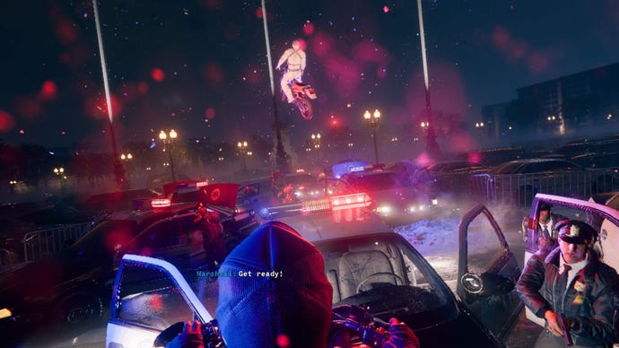 Adler ramps over police cars on a motorcycle.