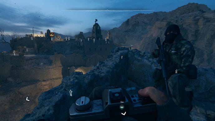 The player equips a camera to examine distant enemies in the Iraqi desert.