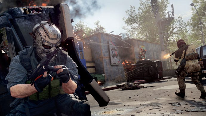 An image from Call Of Duty: Warzone and Black Ops Cold War’s Season 4 Reloaded update, which shows a masked operator ducking for cover behind an overturned vehicle as a firefight breaks out.
