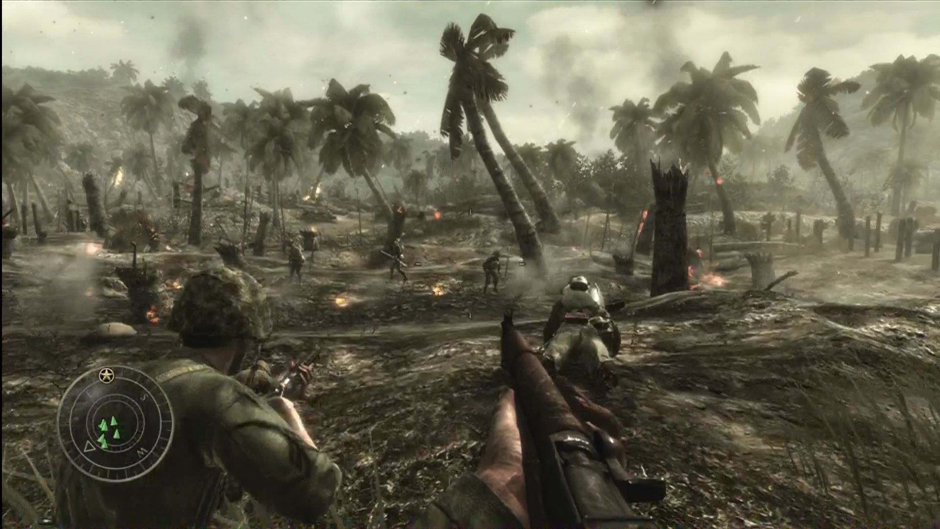 Soliders storm a battlefield - littered with mud and palm trees - in the Pacific theatre in Call of Duty: World at War. - 3