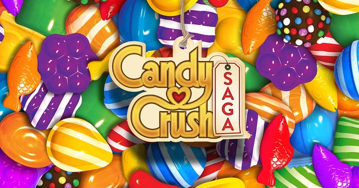 Candy Crush Saga logo on top of a bunch of the games candy pieces