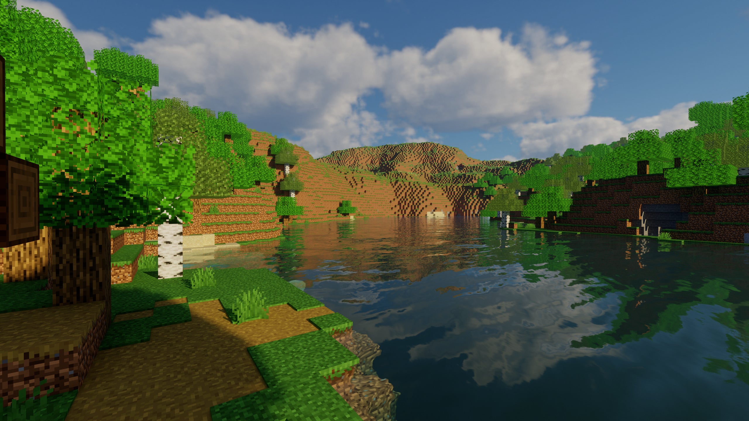 A screenshot of a river in Minecraft, with some trees on either side of the bank and a hill in the distance, taken using Chocapic