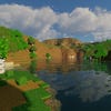 A screenshot of a river in Minecraft, with some trees on either side of the bank and a hill in the distance, taken using Chocapic's shaders.