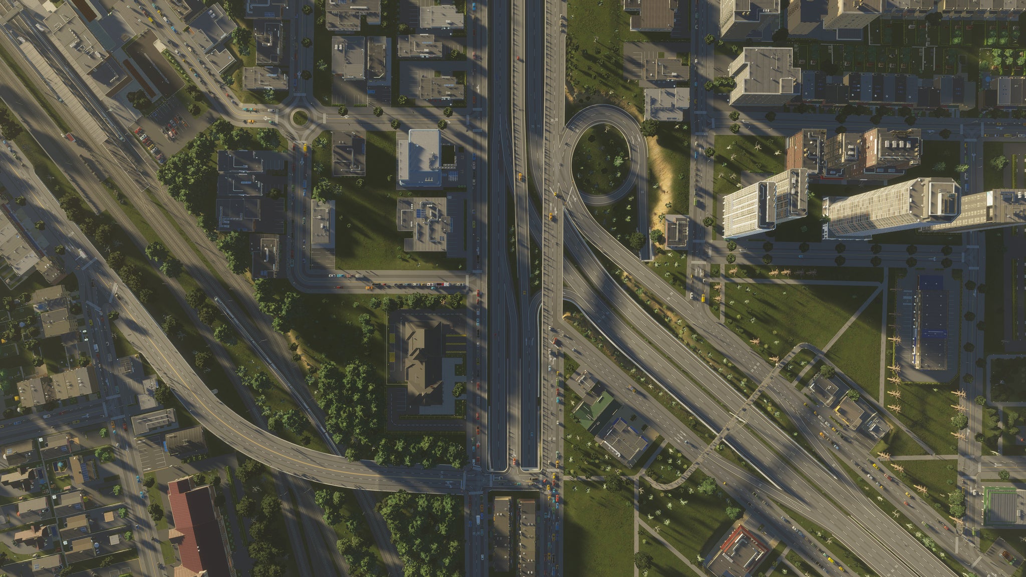A top-down shot of a turnpike, a residential distrcit and some skyscrapes in Cities Skylines 2. - 5