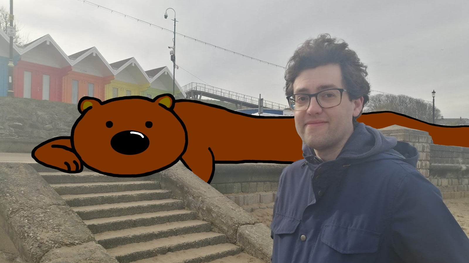 Our news writer CJ Wheeler smiles next to Horace, the endless brown bear of RPS