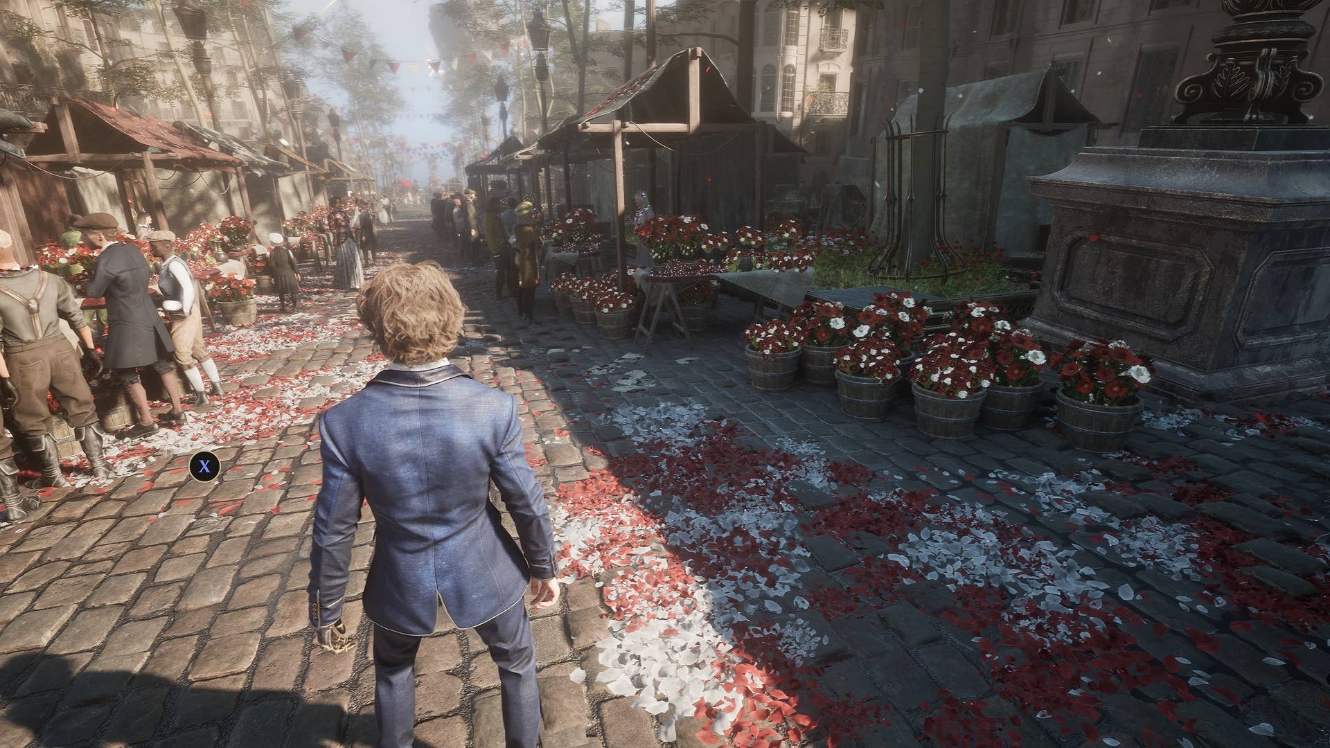 A smartly dressed man in an old-fashioned blazer and trousers standing on a cobbled street at a market that's littered with red and white flowers.