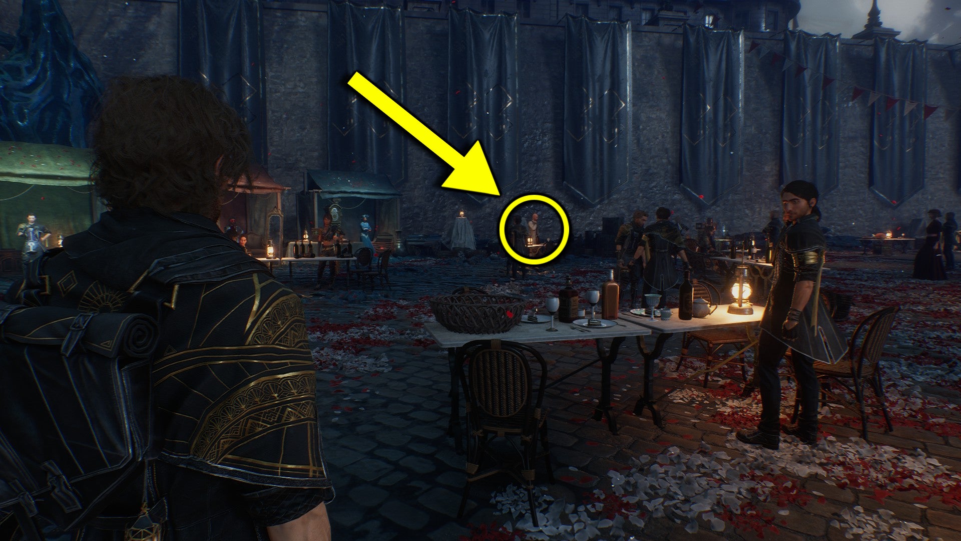 A screenshot from Clair Obscur: Expedition 33, highlighting Antoine's location behind a white table in the Gommage Festival. - 3