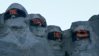 A shot from what appears to be a Call of Duty 2024 teaser site showing the presidents of Mount Rushmore wearing blindfolds covered in orange graffiti reading, "The truth lies".