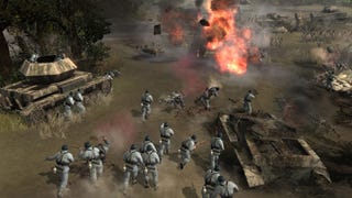 Soldiers storm a muddy battleground in Company Of Heroes