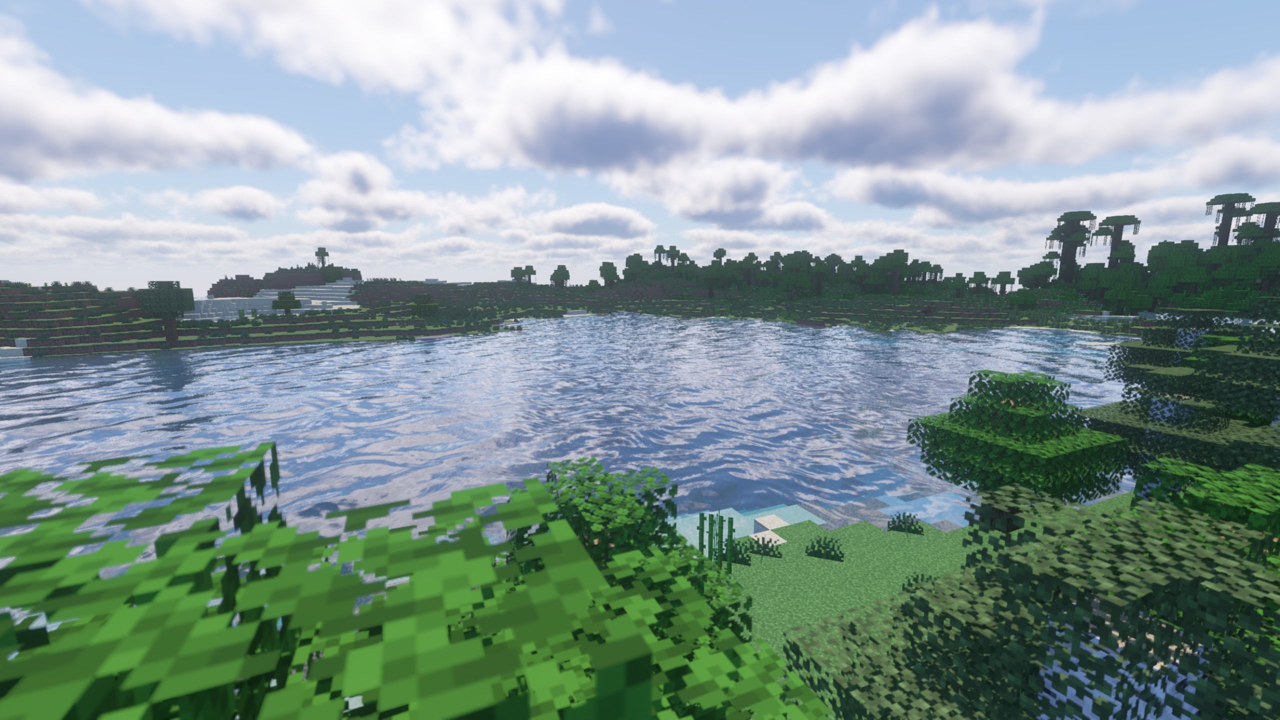 A lake between two forests in Minecraft showcasing Continuum Shaders.