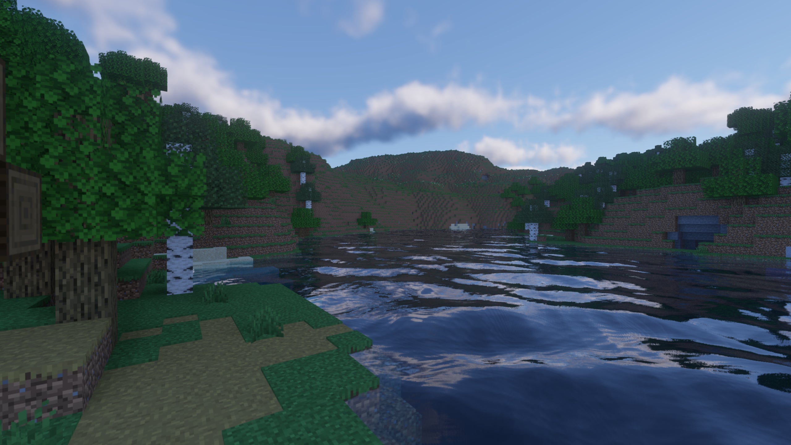 A screenshot of a river in Minecraft, with some trees on either side of the bank and a hill in the distance, taken using Continuum shaders.