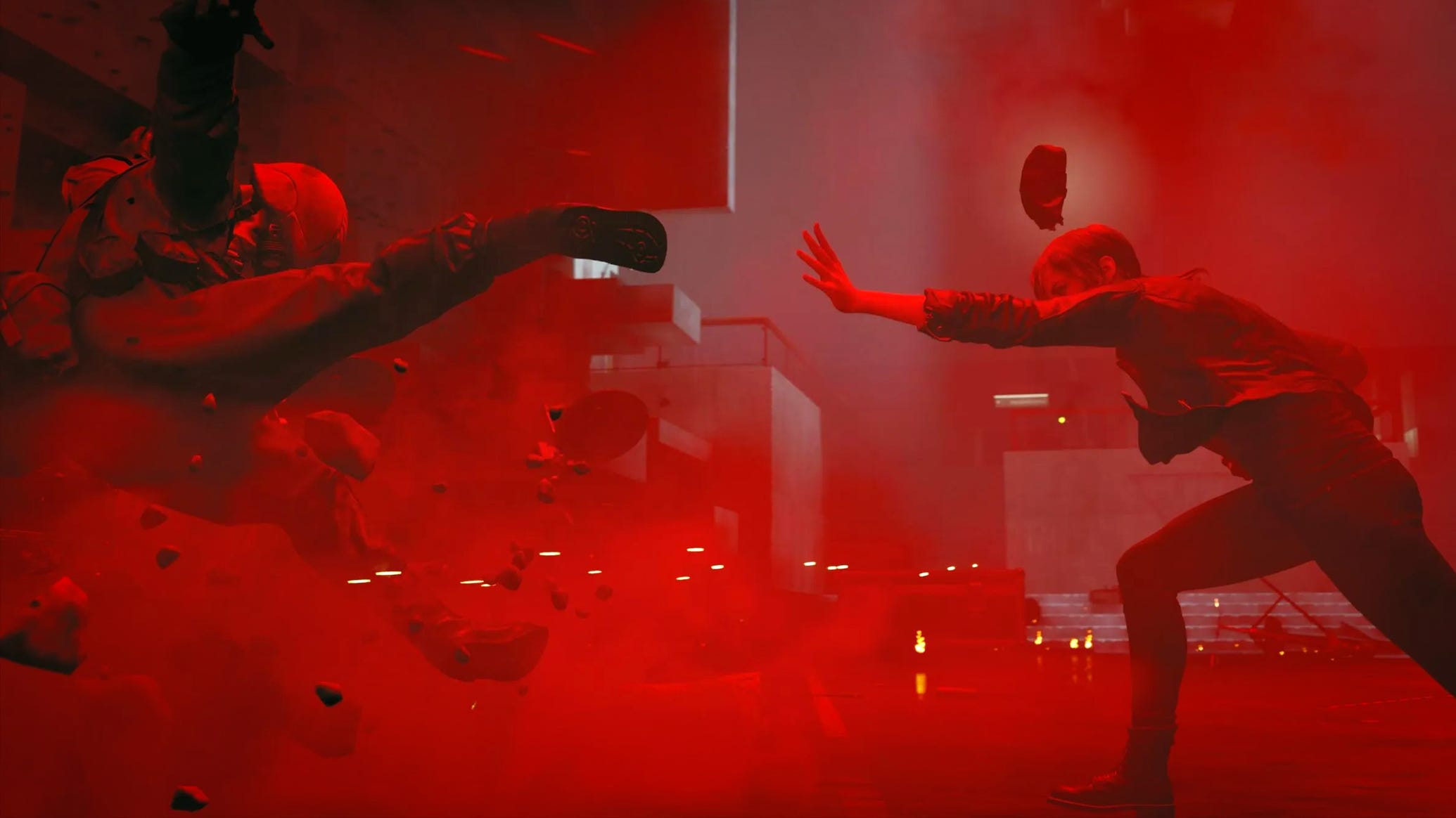 A screenshot from Control showing one character forcefully throwing another armoured soldier character into a wall. It looks like they've done it with telekentic powers. The image is hued in vibrant red.