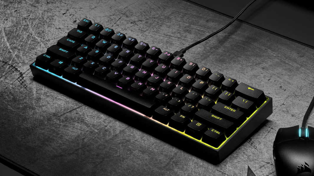 The Corsair K65 Mini gaming keyboard on a desk.