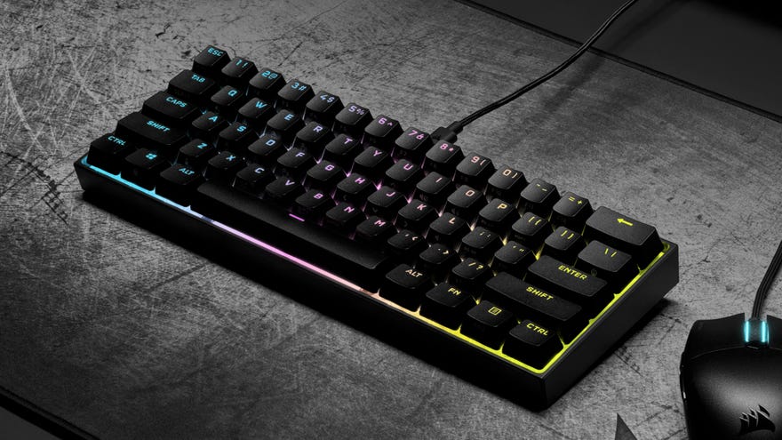The Corsair K65 Mini gaming keyboard on a desk.