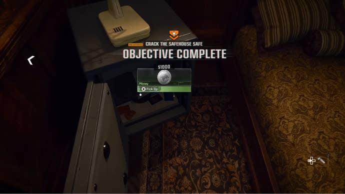 An “Objective Complete” message appears, along with a reward of $1000, after the safe in the safehouse is opened in Black Ops 6.