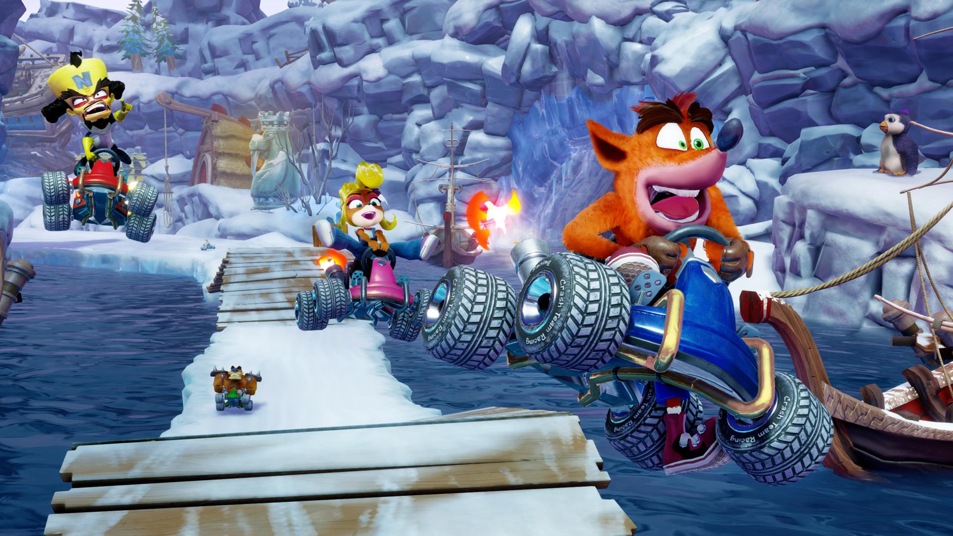 Crash, Coco, and Cortex all leap into the foreground in an icy track in Crash Team Racing Nitro Fueled Remaster. - 5