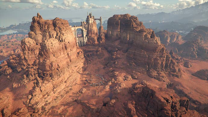 A tower sits between two desert peaks.