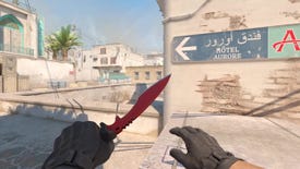 A CS2 player holds a crimson knife in their left hand on Dust 2.
