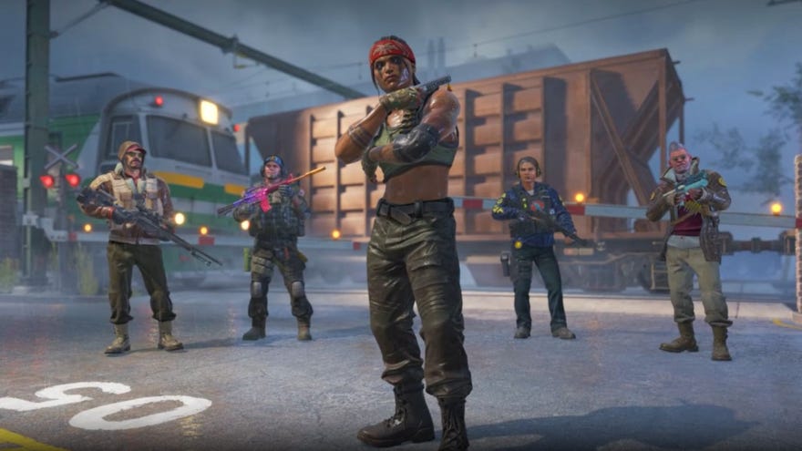 Five soldiers stand at a rainy train platform.