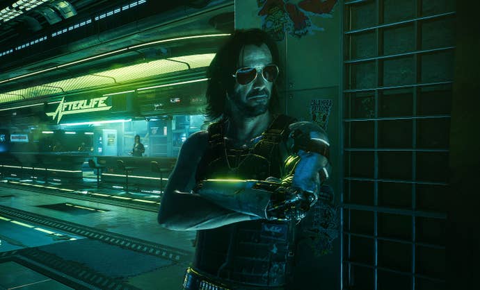 Johnny leans against the wall in Afterlife, with the bar visible in the background.