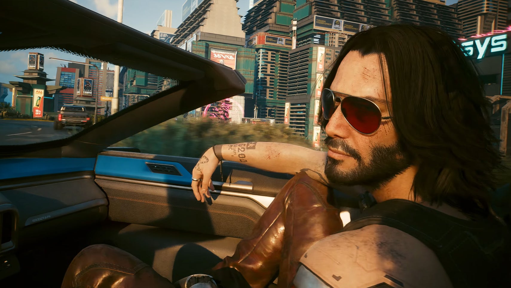 Johnny Silverhand, a man with long hair and big shades, looking at you while you're driving in Cyberpunk 2077. - 1