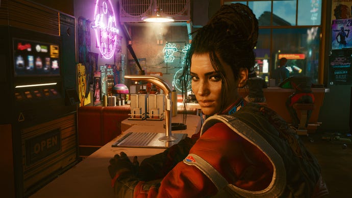 Panam is sitting at a bar in a Cyberpunk 2077 screenshot.