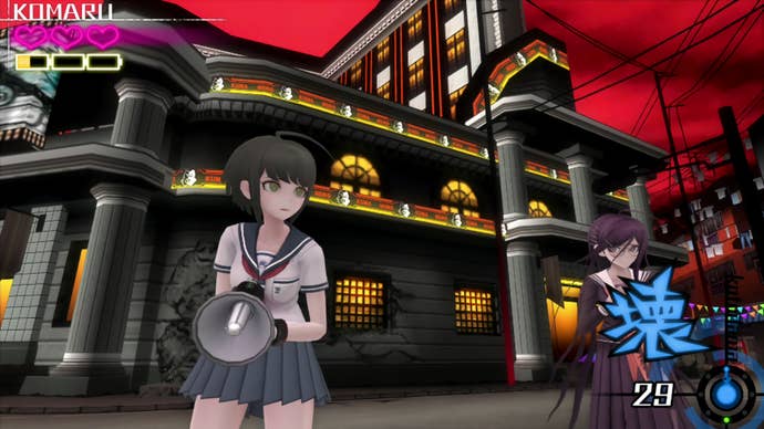 Komaru clutches her bullhorn-style gun and looks fearful as she and Toko stand in front of a city building.