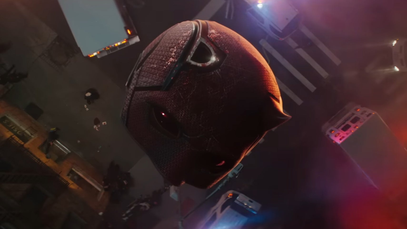 Daredevil's signature red helmet is falling towards a city street, one of its horns broken off in Daredevil: Born Again. - 1